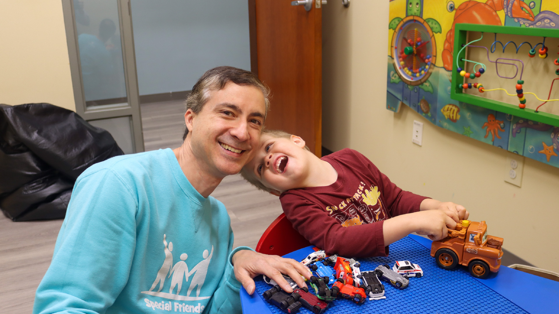 A special needs child and a Brookwood Church Special Friends Volunteer playing games